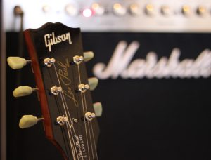 A picture of a guitar headstock representing a link to the Charts Music Studio 'About Us' page